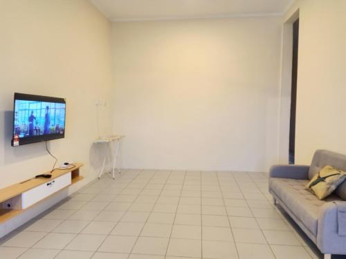 a living room with a couch and a tv at BS Home in Miri City - 3R2B House Pelita Commercial Centre in Miri