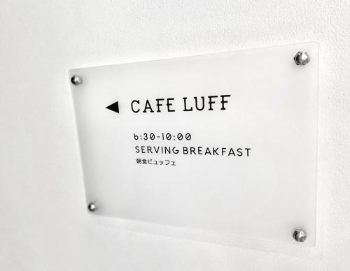 a white plate with a sign on a wall at HOTEL SAILS in Osaka
