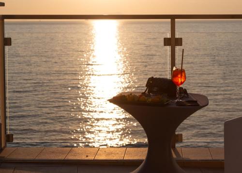 a table with a plate of food and a view of the water at Hotel Giosue' a mare Sorrento in Meta