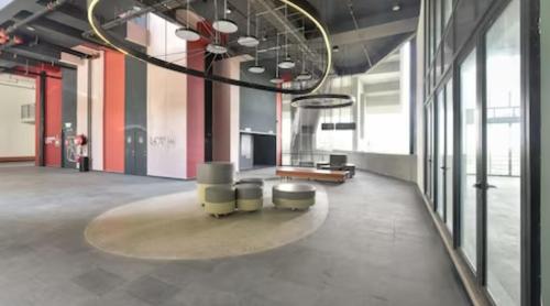 a large room with a table and chairs in a building at Kory Homes Relax in Cyberjaya