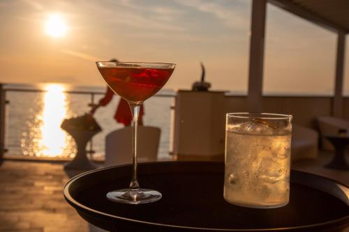 a martini and a glass on a table at Hotel Giosue' a mare Sorrento in Meta