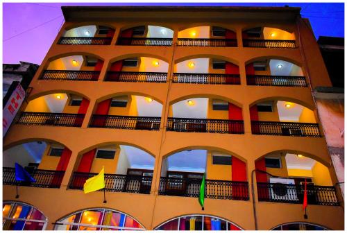 a tall building with balconies and flags on it at HOTEL CITADEL in Vasco Da Gama