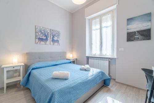 um quarto com uma cama azul e uma janela em Crocetta District! Bright & Roomy Apartment em Turim
