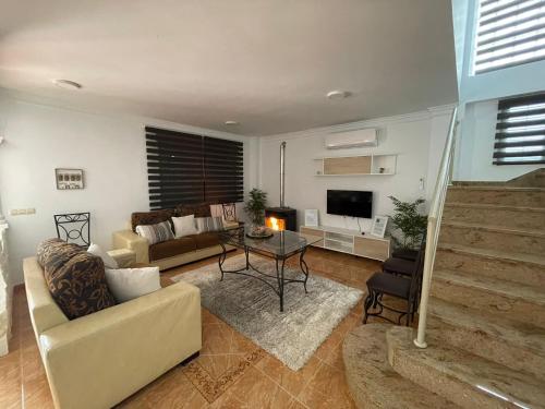 a living room with a couch and a table at ALOJAMIENTO Rural AVD SIERRA MÁGINA in Carchelejo