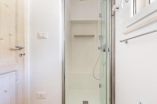 a shower in a bathroom with a glass door at Casale La Stella by Perle di Puglia in San Michele Salentino