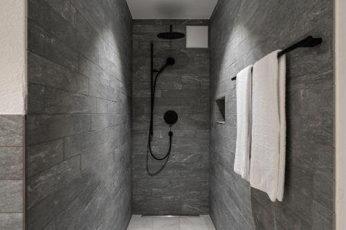 a bathroom with a shower in a wall at Melchtal Resort Apart Hotel in Melchtal