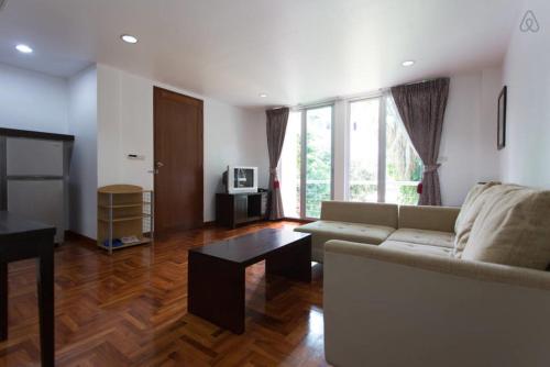 a living room with a couch and a table at P.K. Garden Home in Bangkok