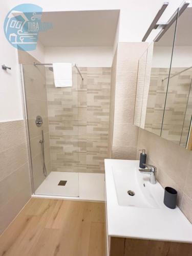 a bathroom with a shower and a sink at Piazza della Borsa 3B Tirabora Short Rent in Trieste