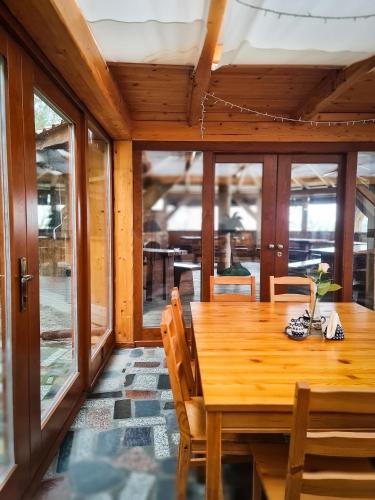 a dining room with a wooden table and chairs at Gościniec Gryszczeniówka & SPA in Wargowo