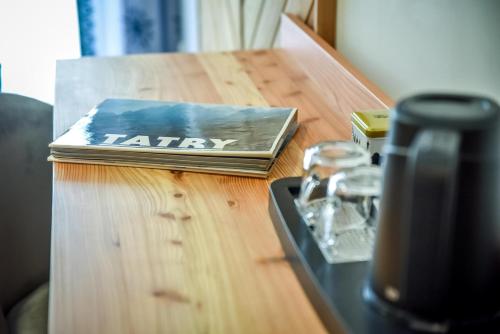 a book sitting on top of a wooden table at My Tatra Residence in Zakopane