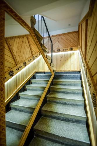 a staircase in an old building with wooden walls and wooden floors at My Tatra Residence in Zakopane