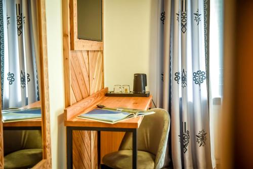 a room with a desk with two chairs and a mirror at My Tatra Residence in Zakopane