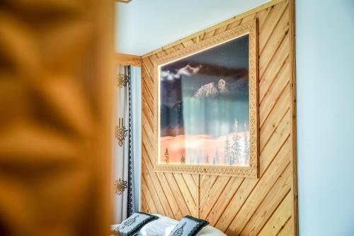 a picture in a wooden wall with a picture on it at My Tatra Residence in Zakopane