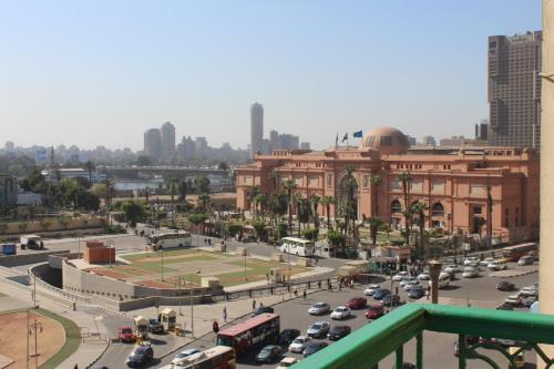 a busy city street with traffic in front of a building at City View Museum Hotel in Cairo