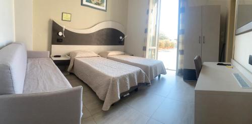 Ένα ή περισσότερα κρεβάτια σε δωμάτιο στο Hotel Roma