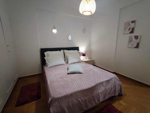 a bedroom with a large bed with two pillows at OLGAS SQUARE APARTMENT CKBSM in Patra