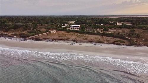 an aerial view of a house on an island in the ocean at Villa Le P’tit Paradis in Ngalou Sessène