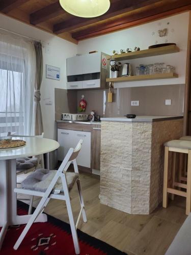 a kitchen with a table and a table and chairs at Apartman Čaroban odmor Divčibare in Divčibare