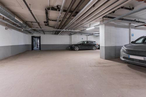a parking garage with two cars parked in it at Courtyard by Marriott Stockholm Kungsholmen in Stockholm