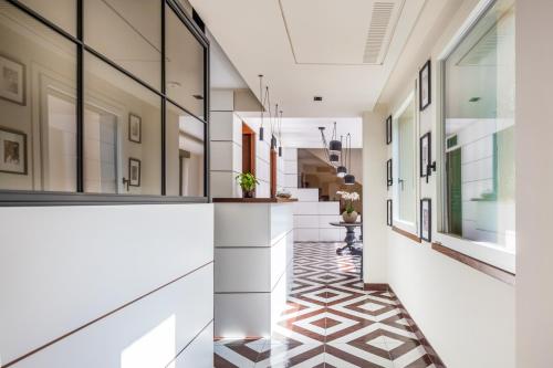 a hallway of a building with white walls and tile floors at Gargiulo Resort in Sant'Agnello