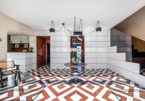 a hallway with a tile floor and staircase with a table at Gargiulo Resort in Sant'Agnello