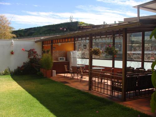 a house with a patio with a table and chairs at Hotel Sumaq Kay in Cumbayá