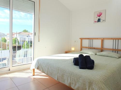 a bedroom with a bed and a large window at Villa Ariana in L'Ametlla de Mar