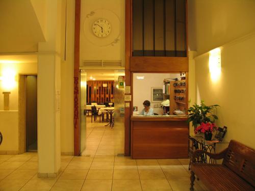 a kitchen with a clock on the wall at Hotel Cecco in Arezzo