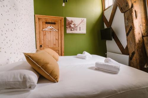 a bedroom with two beds with green walls at De Molen van Egmond by Droomvilla in Egmond aan den Hoef