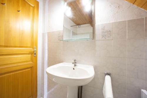 a bathroom with a white sink and a mirror at Appartement 10 in Saint-Sorlin-dʼArves