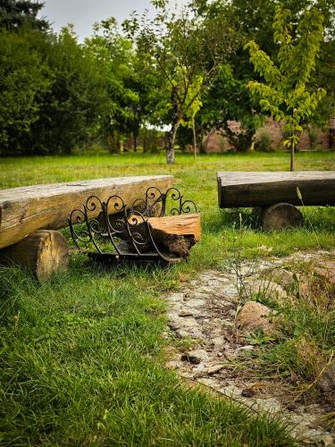 a wooden bench sitting in the grass in a park at Gościniec Gryszczeniówka & SPA in Wargowo