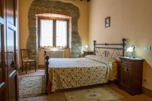 a bedroom with a bed and a window at Villa Orizzonte - Homelike Villas in Todi