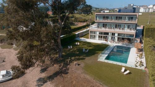 an aerial view of a house with a swimming pool at Malates Slow Boutique Hotel in Foz