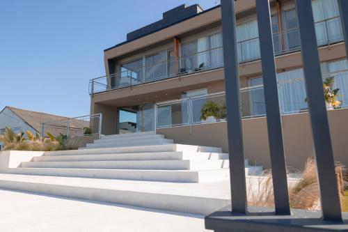 a building with stairs in front of it at Malates Slow Boutique Hotel in Foz