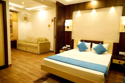 a hotel room with a bed and a couch at Hotel Avenue Plaza, Serampore - N S Avenue 