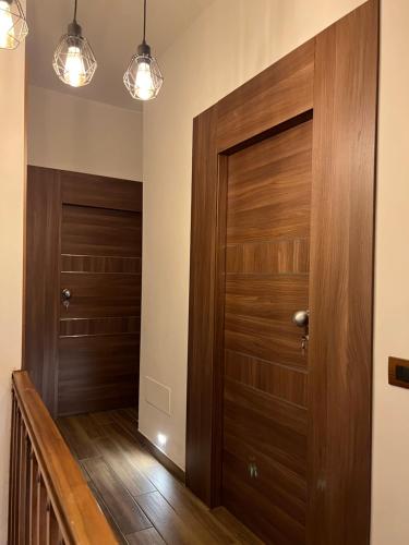 a hallway with wooden doors and wooden floors at Rifugio Federici Home & Spa in Camigliatello Silano