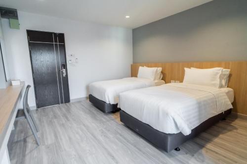 Ένα ή περισσότερα κρεβάτια σε δωμάτιο στο Goodday Hotel