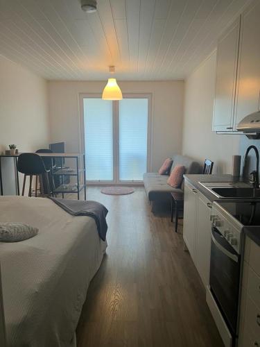 a room with a kitchen and a living room at Modern apartment nearby Kerava2 in Kerava