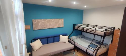 a room with two bunk beds and a couch at Blue apartment in City Center, Best location in Bratislava