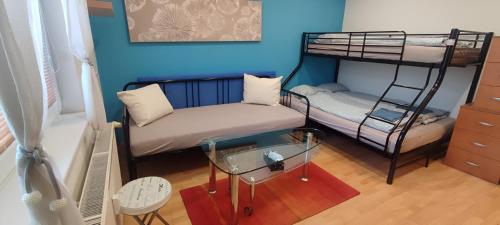 a living room with two bunk beds and a glass table at Blue apartment in City Center, Best location in Bratislava