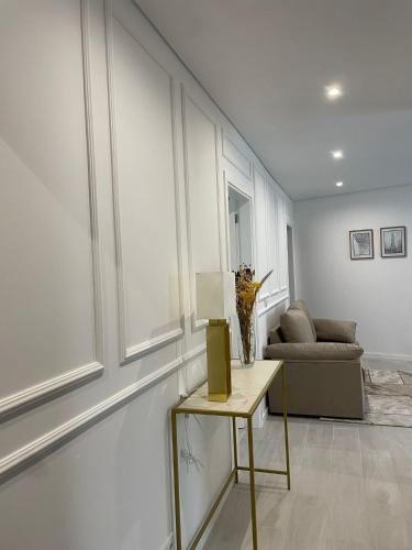 a living room with a table and a couch at Marinho's Oporto Apartments in Porto