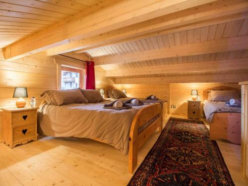 a bedroom with a large bed in a log cabin at Nordic Lodge in Peisey-Nancroix