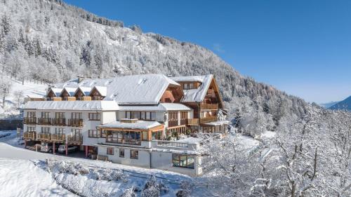 an image of a house in the snow at nawu apartments & Restaurant in Hermagor