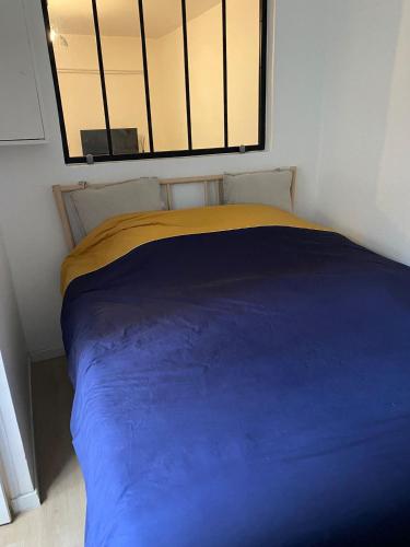 Säng eller sängar i ett rum på Au pied du Sacré Cœur