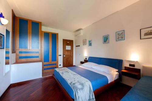 a bedroom with a blue and white bed in it at Torrebianca Tuscany in Rignano sullʼArno