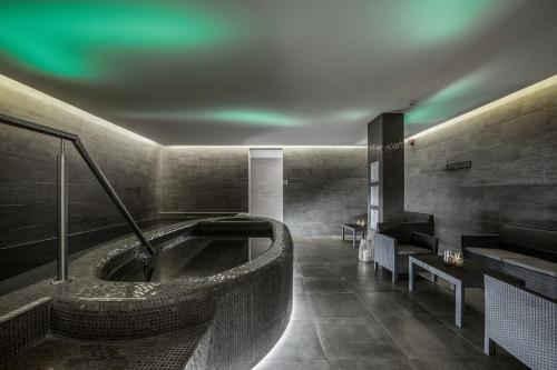 a bathroom with a tub in the middle of the room at Hotel Ísland – Spa & Wellness Hotel in Reykjavík