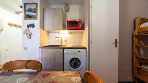 Il comprend une petite cuisine équipée d'un lave-linge et d'un four micro-ondes. dans l'établissement Grande Neige 23 - Appt pied des pistes 4 pers, à Morillon