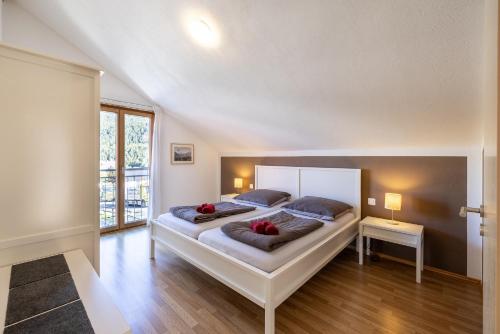 a bedroom with two beds with red flowers on them at Pütvia 245F in Scuol