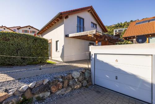 a white garage door in front of a house at Pütvia 245F in Scuol