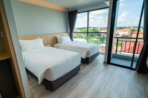 Ένα ή περισσότερα κρεβάτια σε δωμάτιο στο Goodday Hotel